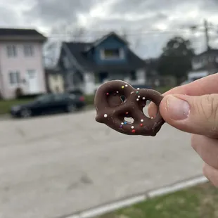 a chocolate pretzel with sprinkles