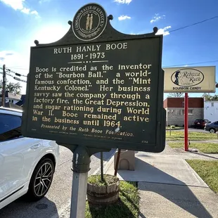 a historical sign on the corner of a street