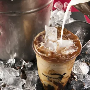 iced coffee being poured into a cup