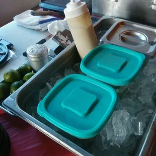 a tray of ice cubes and a container of ice cubes