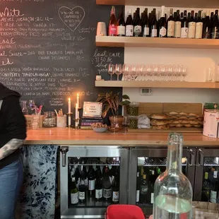 a woman standing in front of a bar