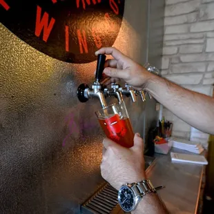 a man pouring a beer