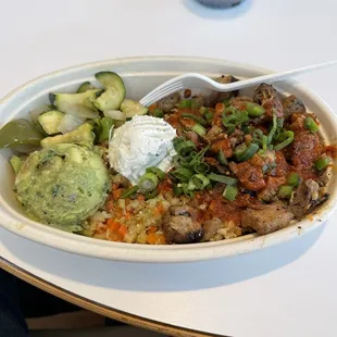 Chicken, cauliflower rice, veggies, guacamole, goat cheese