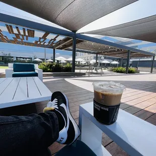 a person sitting at a table with a cup of coffee