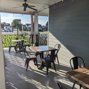 a patio with tables and chairs
