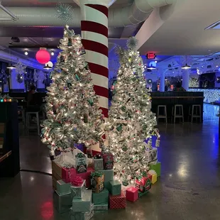 a christmas tree with presents in front of it