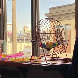 a man looking out a window at a toy hamster
