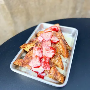 a plate of french toast with strawberries