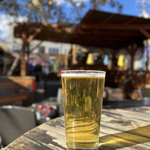 a pint of beer on a wooden table