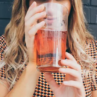 a woman drinking a pint of beer