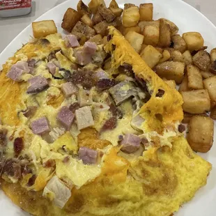 Meat lovers omelette, home fries and a biscuit.