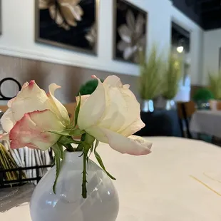 a vase of roses on a table