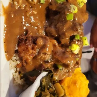 Oxtails with Country Gravy over rice, southern Greens with ham hocks and Jalapeño Corn bread