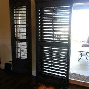 The perfect solution for a patio door - bypass wooden shutters.