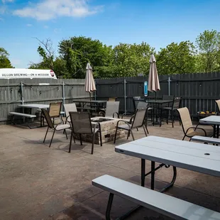 a patio with tables and umbrellas