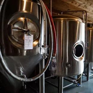 a row of stainless steel tanks