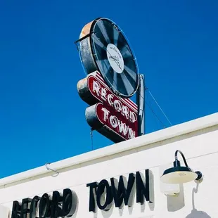 The Record Town sign and part of the storefront on a bright sunny day.