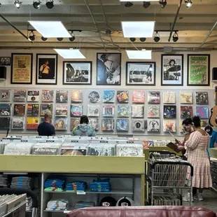 Inside shot of Record Town and a couple of folks shopping in one of the discount carts finding treasures.