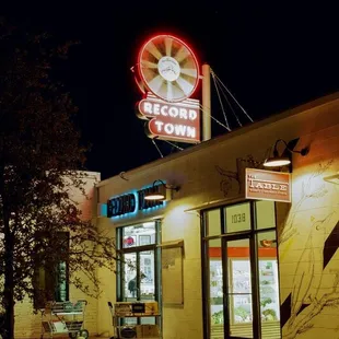 Outside of Record Town at night. We are open every night until 8pm except on major holidays.