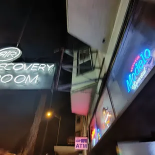 a neon sign on the side of a building