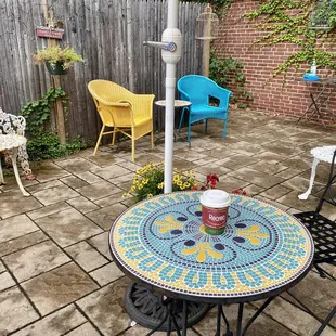 a patio with a table and chairs