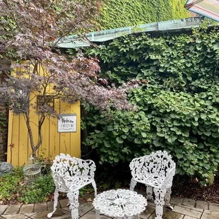two white chairs and an umbrella