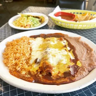 a plate of enchiladas and rice