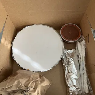 Nicely packaged enchiladas, in a bakery box with tortillas, chips and salsa.