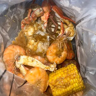 Seafood boil: blue crab and head on shrimp. Hot &amp; house blend seasoning
