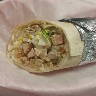 a burrito wrapped in aluminum foil