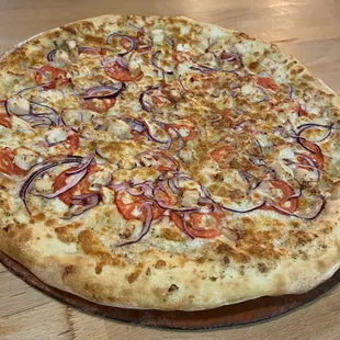Our most popular pie, The Garlic Chicken; chicken, tomato, red onion and the soon-to-be-famous white sauce!