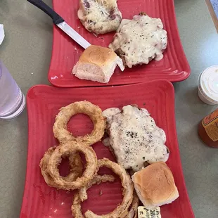 Large chicken fried steak plate split in two with onion rings and cream potatoes