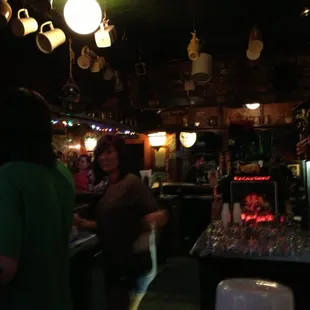 a woman standing at the bar