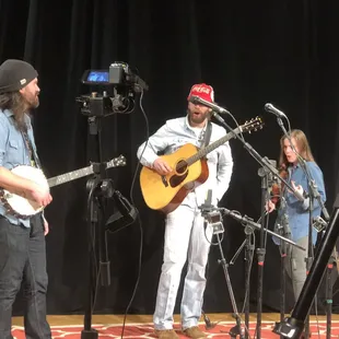 a man playing guitar and a woman singing