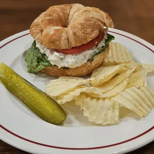 a croissant sandwich and chips