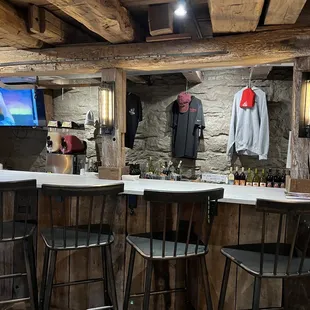 a bar with stools and a television