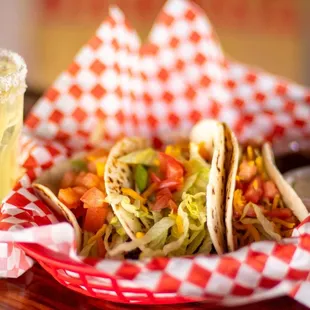 Our taco basket comes with three flour tortillas stuffed full of beans, beef, and veggies.  Served with sour cream and homemade salsa.