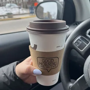 a person holding a cup of coffee