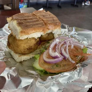 Vada Pav is a vegan dish made with seasoned potato dumpling and sandwiches in a slider roll.