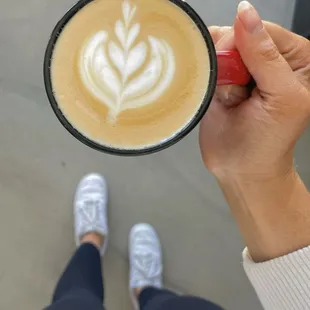 a person holding a cup of coffee