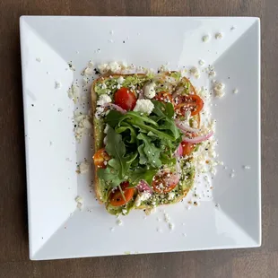 Avocado Elevated Toast

Mashed avocado, cherry tomato, sweet pickled onion, feta cheese, everything bagel seasoning, &amp; arugula