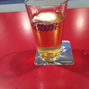 a glass of beer on a red table