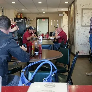 people sitting at tables in a restaurant