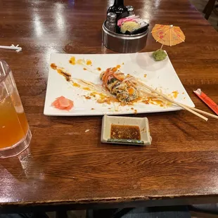 a plate of sushi with chopsticks