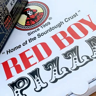 a pizza box on a picnic table