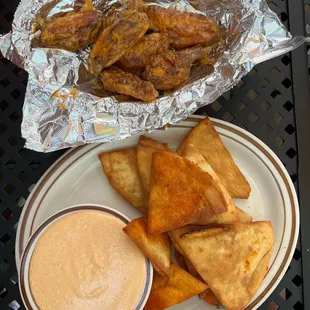 a plate of pita chips and dipping sauce
