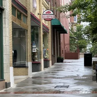 a rainy sidewalk in a city