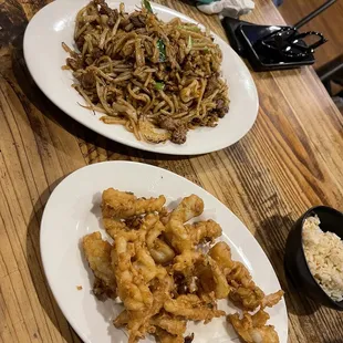 two plates of food on a wooden table