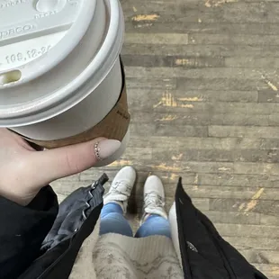 a person holding a cup of coffee