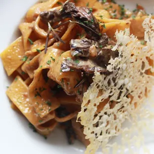 Pappardelle ai Funghi Porcini Homemade pappardelle in a creamy base sauce enriched with dried porcini mushrooms.